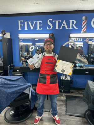 Student holding their new barber license