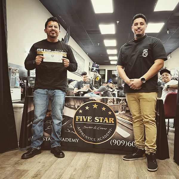 Five Star Academy student holding their new license next to the instructor