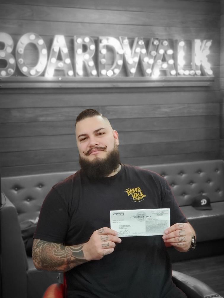 Student holding barber license
